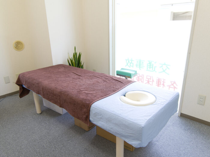 いっぽ整骨院の施術室。窓のそばに施術ベッドを設置した室内